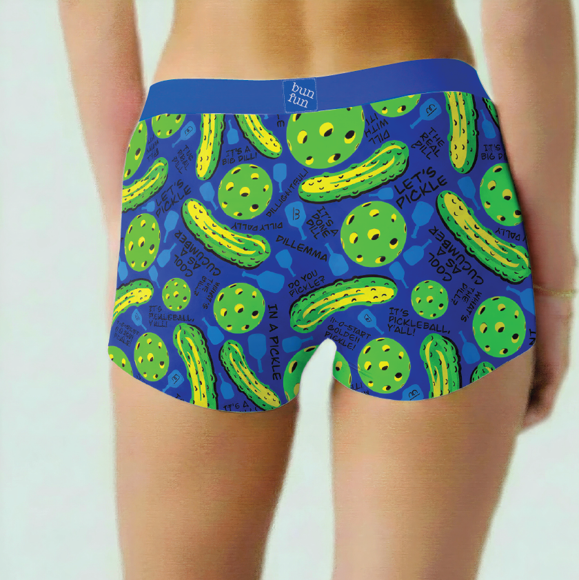 Blue boxer briefs with pickle pattern worn by a person on a white background