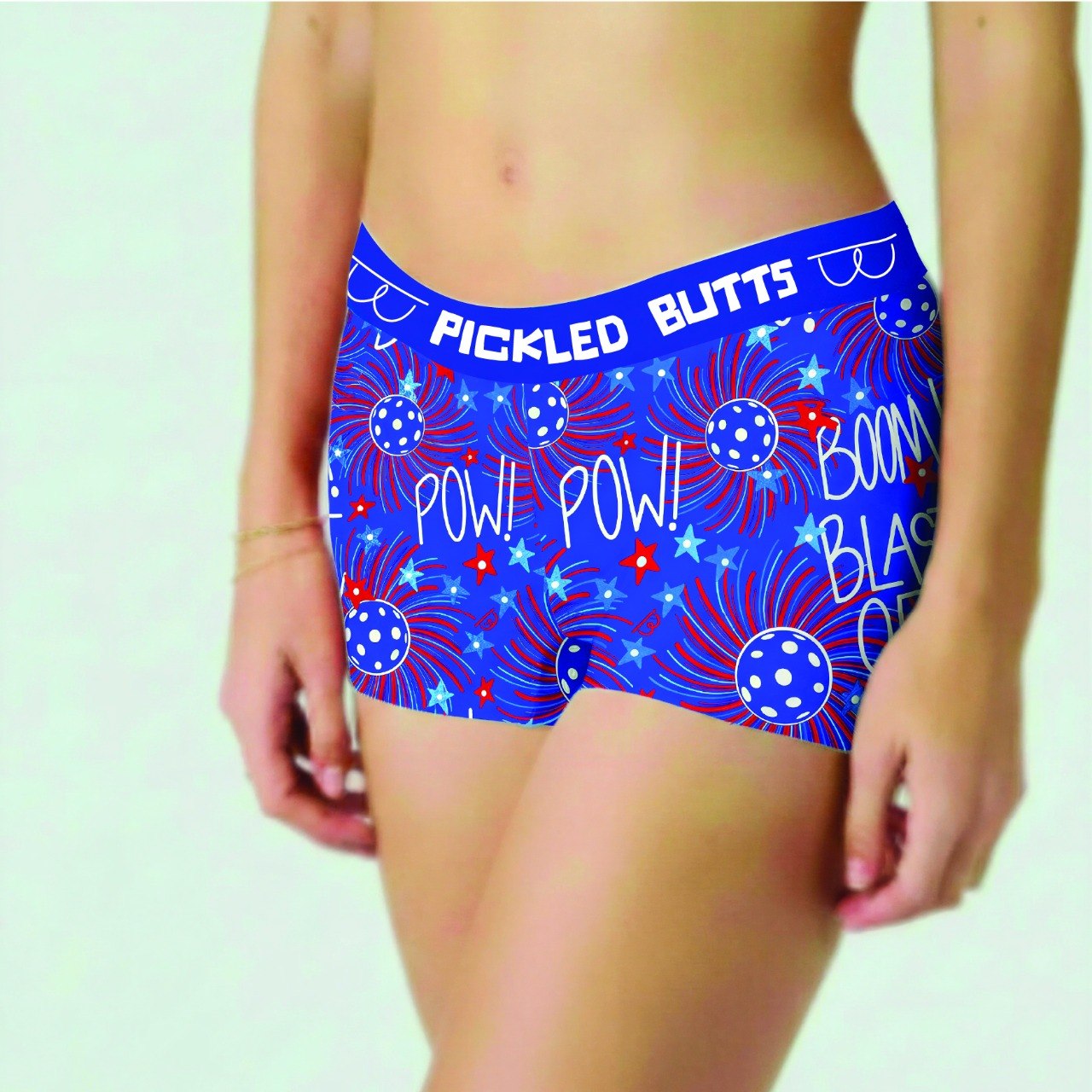 Firework-design-pickleball-underwear-women with red and white text and graphics on a light green background