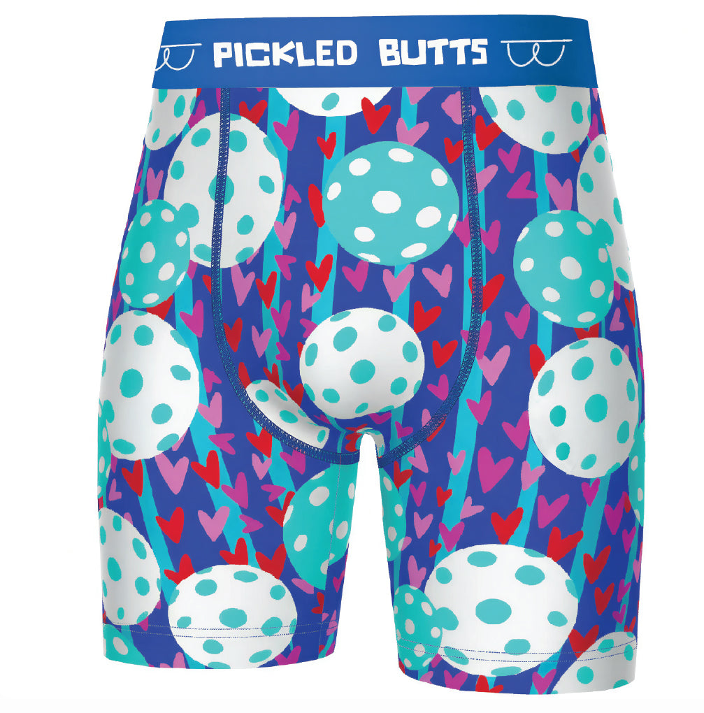 Men's boxer briefs featuring a colorful pattern of white polka-dotted eggs, pink and red hearts, and blue stripes on a dark purple background, with a blue waistband that reads 'PICKLED BUTTS'.
