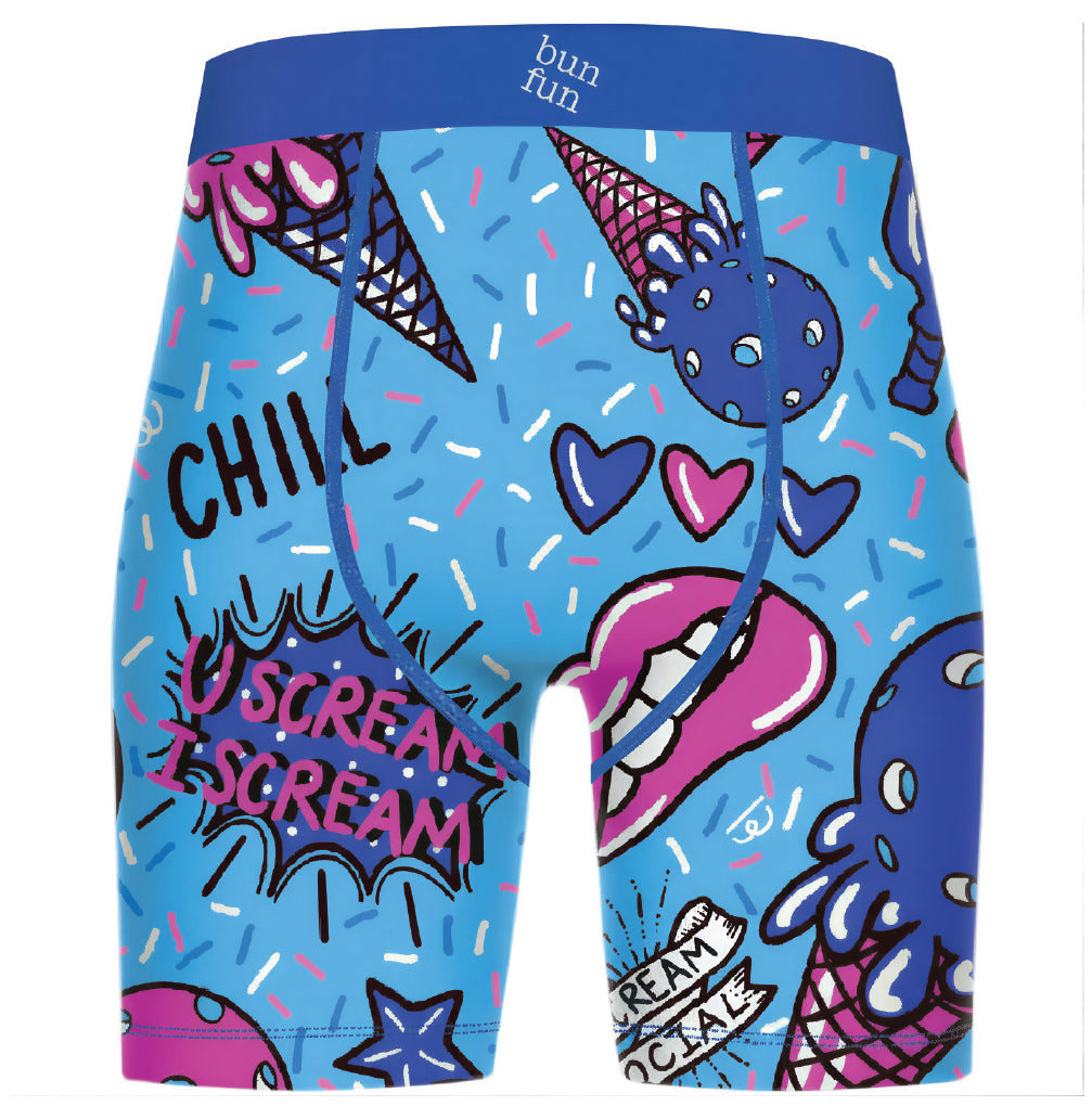A pair of men's pickleball shorts featuring a vibrant, colorful ice cream-themed graphic print on a light blue base. The print includes illustrations of ice cream cones, a blue monster, pink lips, hearts, and comic-style text bubbles reading 'SCREAM' and 'CHILL'.