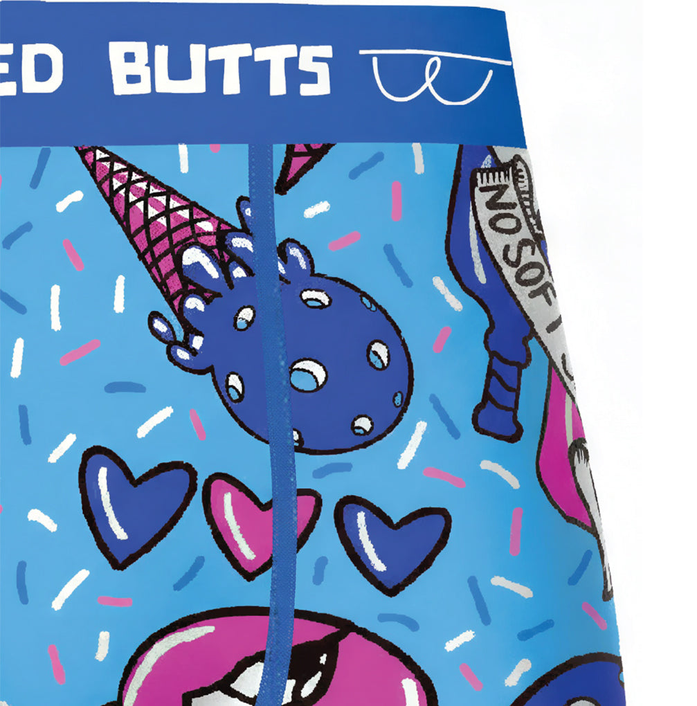 Close-up of a pair of boxer briefs with a bright blue base and a colorful graphic print featuring a blue ice cream scoop, pink lips, purple hearts, and sprinkles. The waistband has white text reading 'ED BUTTS' and a white line-art butt graphic.
