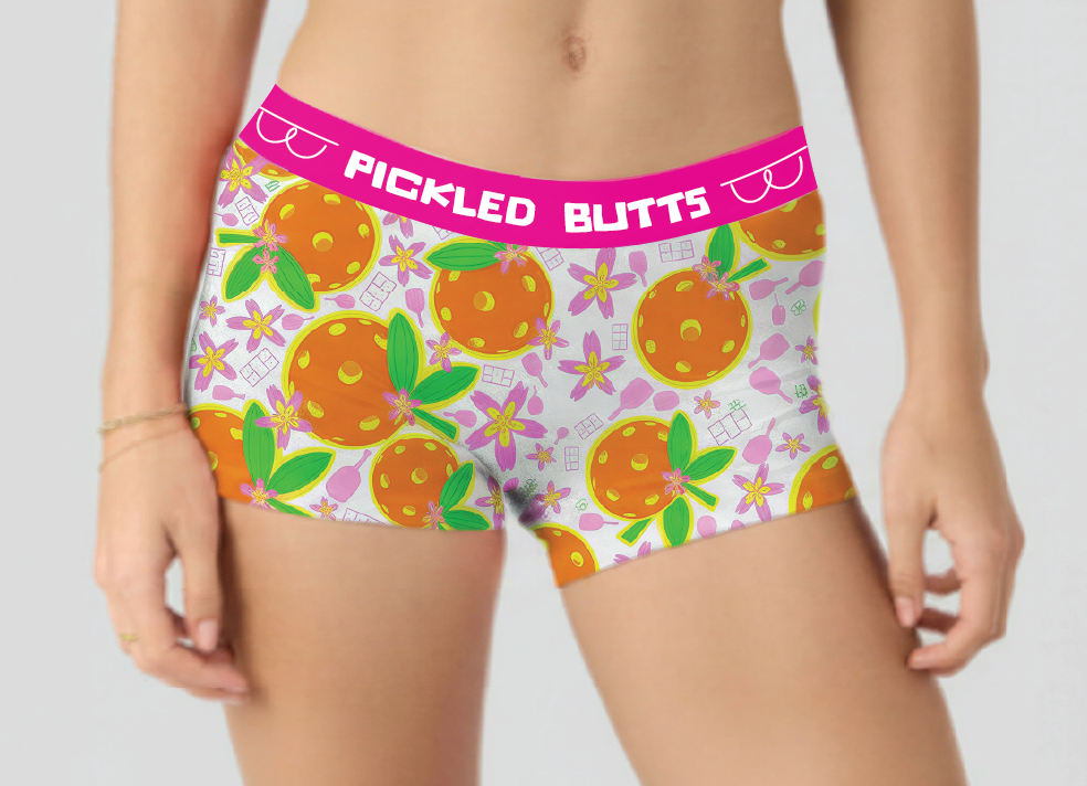 Person wearing a colorful underwear with orange design and 'Pickled Butts' text on a plain background