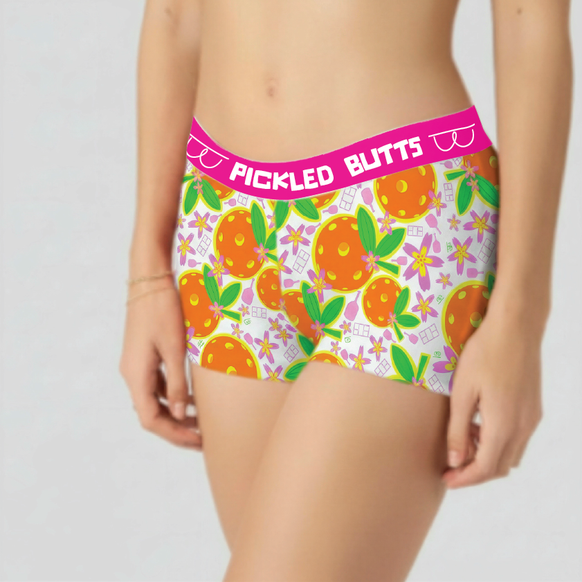 Colorful underwear with orange pattern and pink waistband on a plain background