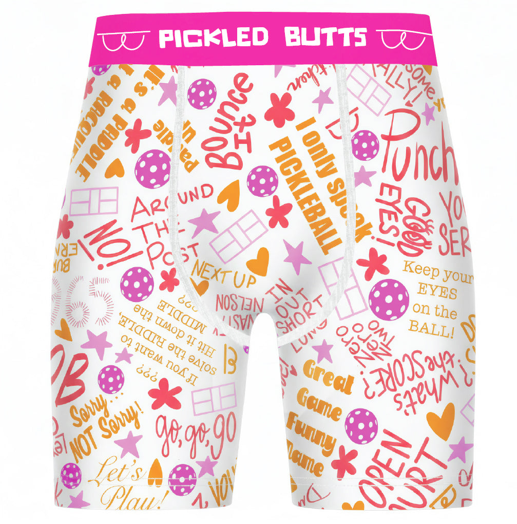 Say What Pickleball Underwear for men with a bright pink elastic waistband reading 'PICKLED BUTTS' and covered in colorful pink, orange, and yellow retro-style text and graphic motifs, shown on a plain white background.