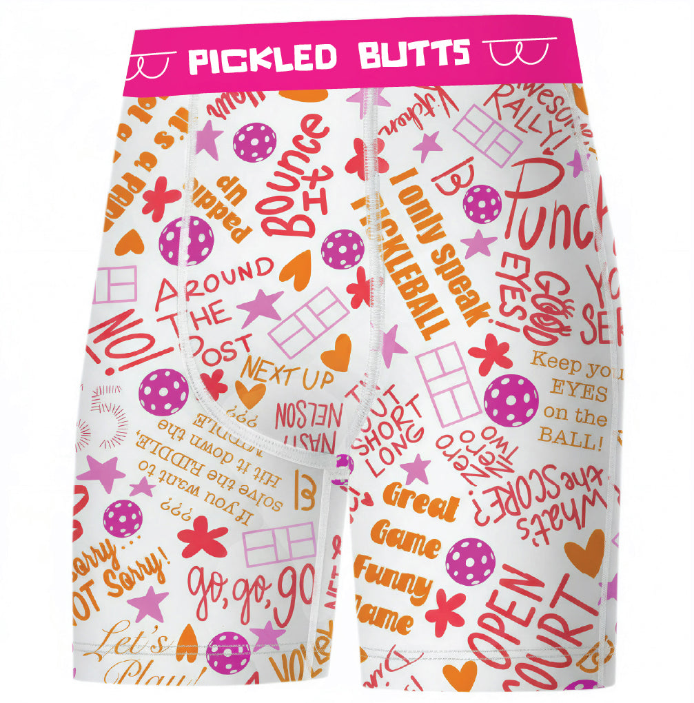 White athletic shorts with a vibrant pink, orange, and purple all-over print featuring sports-themed text, stars, and logos, complete with a bright pink waistband that reads 'PICKLED BUTTS'.
